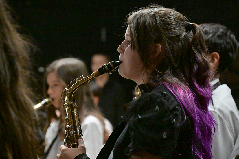 A girl plays alto saxophone