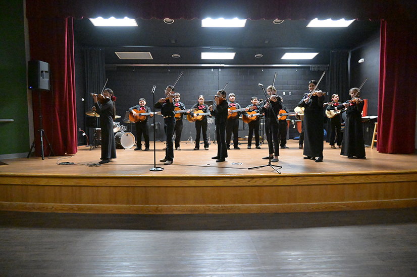 A student mariachi performs onstage