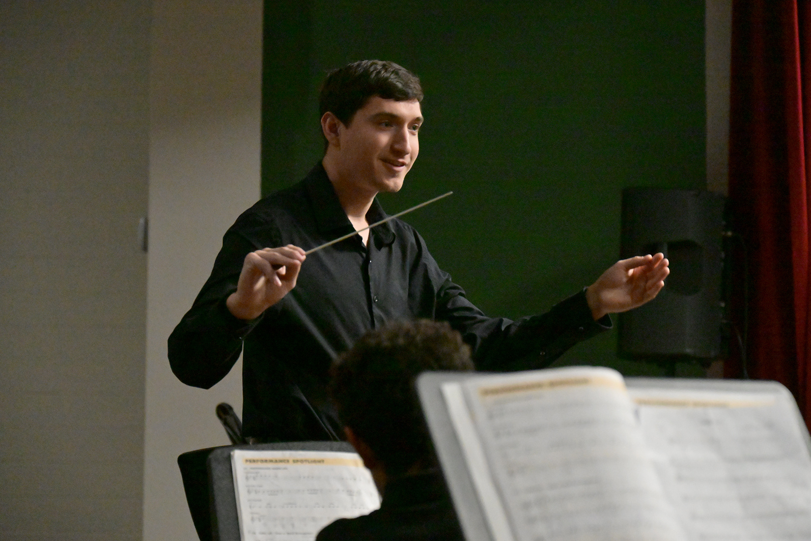 A man conducts the student band